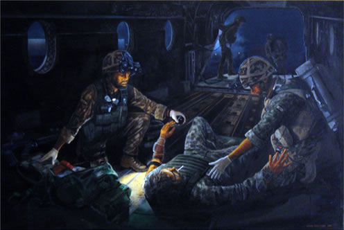 Medics treating a casualty on a Chinook during a night operation